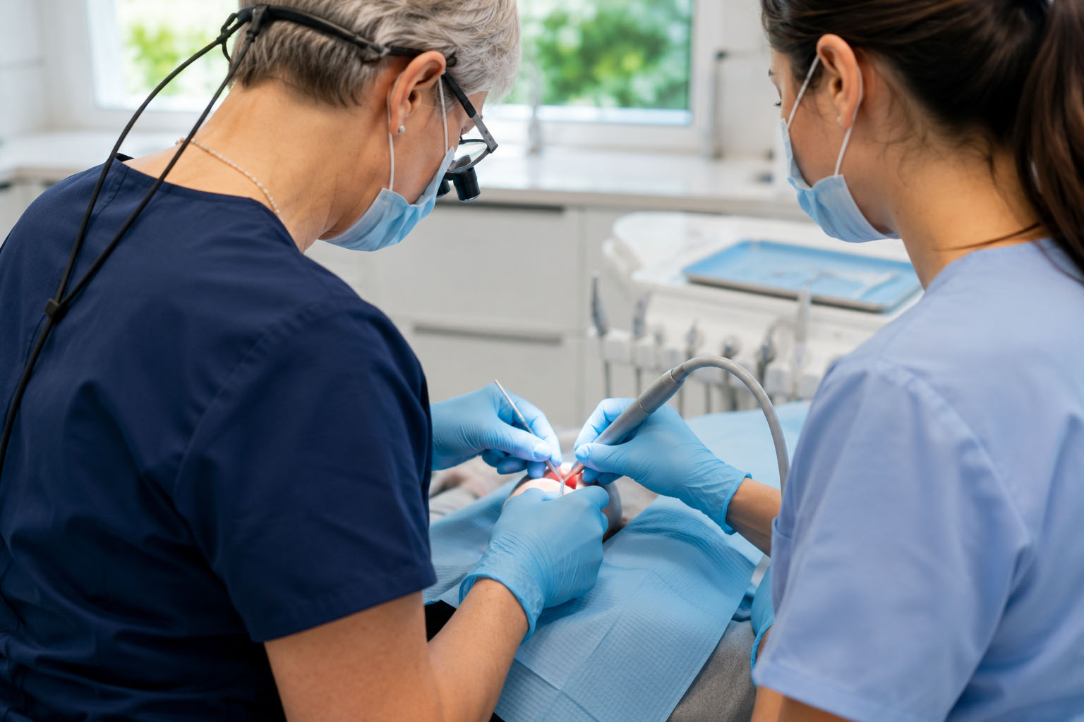 Dr. Haller performing a CO2 laser frenectomy with her assistant.